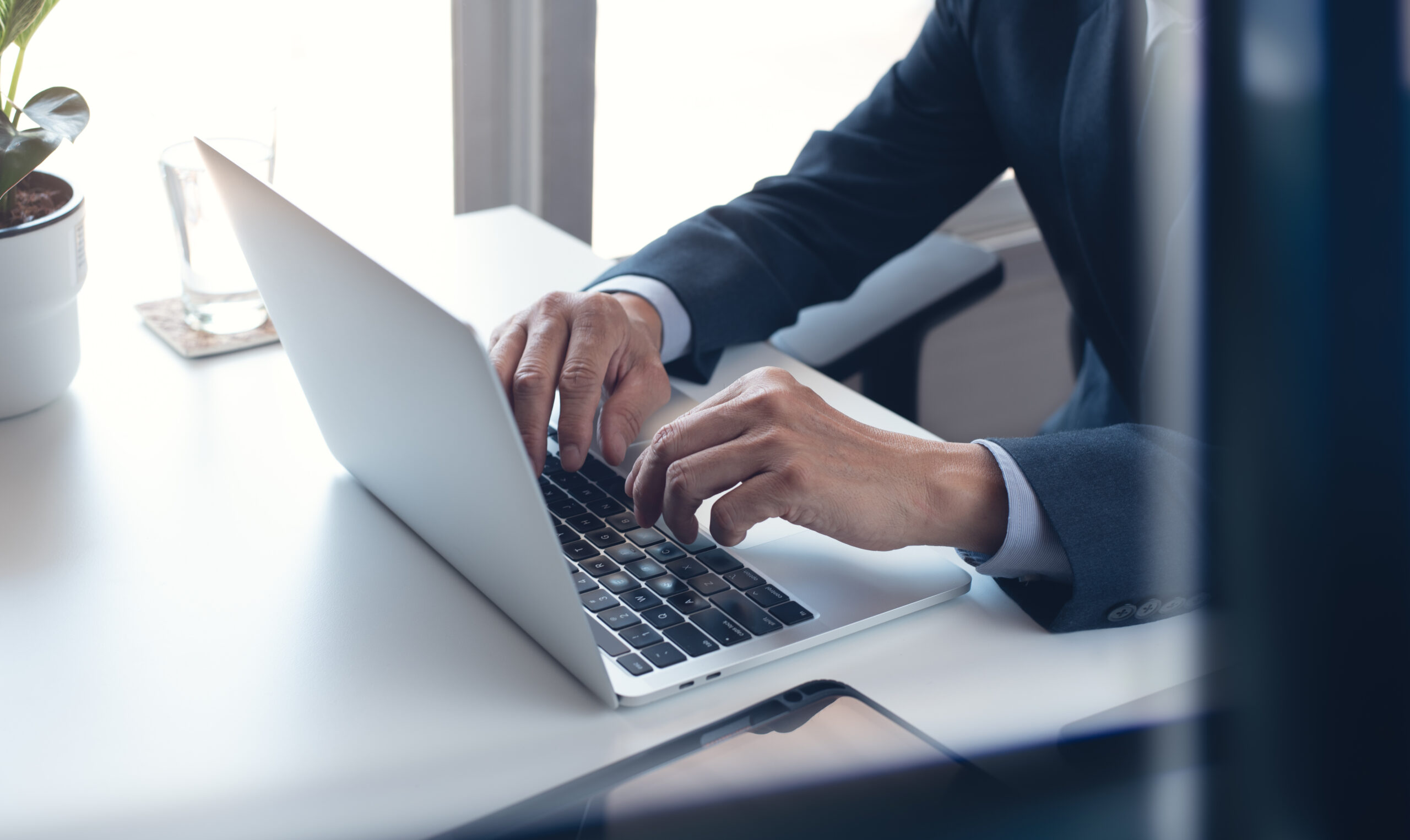 Business man working on laptop computer at modern office. Busine